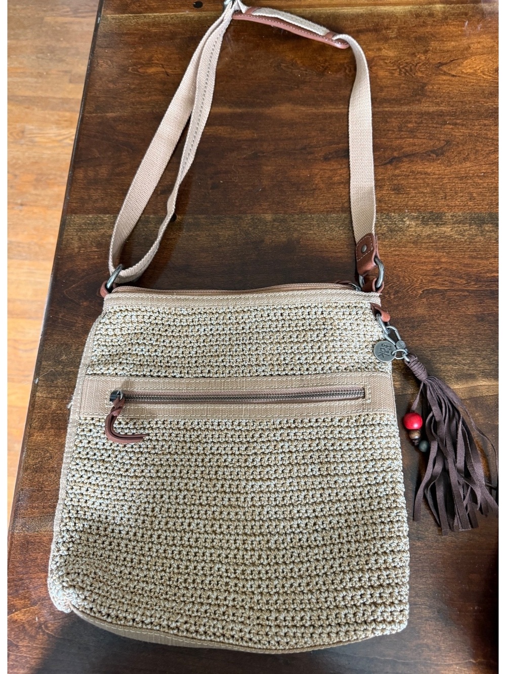 The Sak Beige Crochet Crossbody Shoulder Bag with Tassel Charm